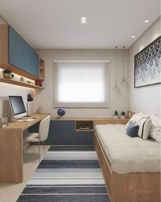 a bedroom with a bed, desk and computer on the wall next to a window