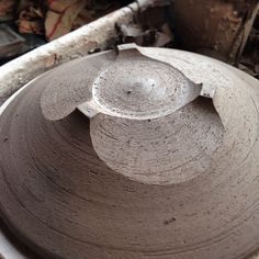 an old pottery bowl sitting on top of a table