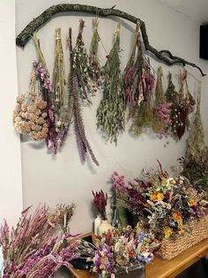 a bunch of dried flowers are hanging on the wall