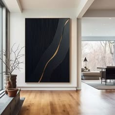 a large painting hanging on the wall in a living room