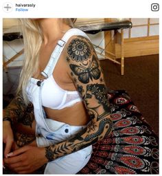 a woman with tattoos on her arms and chest