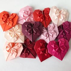 six origami hearts arranged in different colors