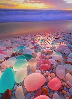 a beach covered in lots of different colored rocks