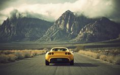 a yellow sports car driving down the road in front of mountains and clouds with an advertisement for the lottey office 45 million