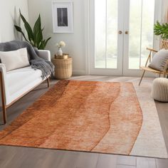 a living room with an orange rug on the floor