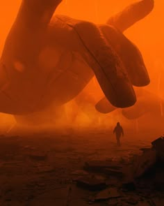 a man is walking in front of a giant object