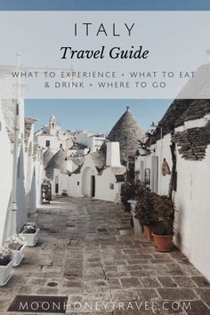 an alley way with white buildings and potted plants on the side, text reads italy travel guide what to experience and what to eat & drink where to go