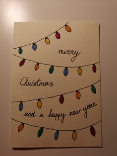 a christmas card with lights hanging from it