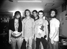 five young men are standing in a room