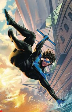 a man flying through the air while wearing a black suit and blue shoes in front of a cityscape