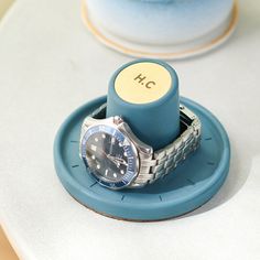 a watch sitting on top of a blue plate