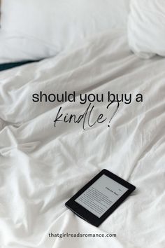 a kindle sitting on top of a bed with the words should you buy a kindle?