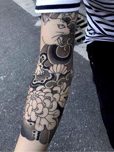 a person with a cat tattoo on their arm