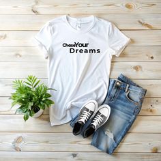 "Chase Your Dream" t-shirt, a perfect blend of motivation and style, designed to inspire you and those around you. This unisex tee is ideal for dreamers, friends, or anyone who loves uplifting messages. Made from 100% ethically sourced US cotton, it offers year-round comfort with its medium fabric weight of 5.3 oz/yd². The smooth surface of the fabric ensures sharp and vivid printing, making the motivational quote "Chase Your Dream" stand out. With no side seams and a tear-away label, it guarant Motivational Tshirt, Dream Sans, Inspirational Tees, Chase Your Dreams, Uplifting Messages, Inspirational Shirt, Motivational Quote, Formal Occasion, Semi Formal