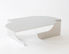 a white table sitting on top of a white floor