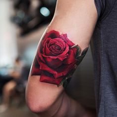 a man with a rose tattoo on his arm