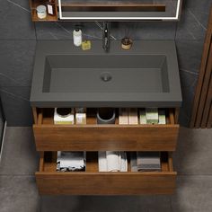 a bathroom sink sitting under a mirror next to a wooden shelf with towels and other items