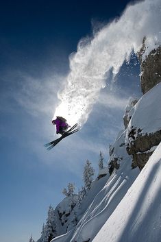 a person jumping in the air on skis