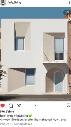 an apartment building with two balconies on the second floor