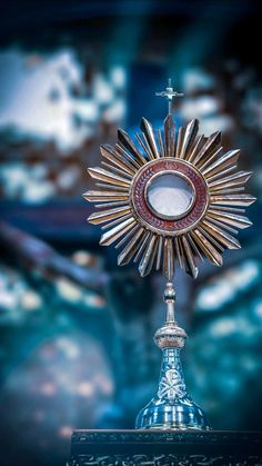 a cross on top of a table with a mirror in the middle and other items around it