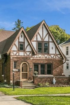 a large brick house with two story windows on the front and side of it's roof