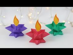 three origami candles sitting next to each other