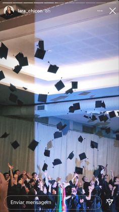 a group of graduates throwing their caps in the air at an event or graduation ceremony