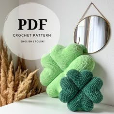 there is a green clover on the shelf next to some plants and a mirror that says pddf crochet pattern english / polish