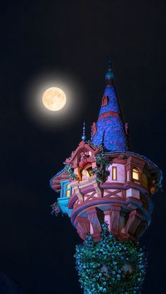 a full moon shines brightly above a building