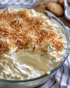 a dessert dish with white frosting and toasted coconut toppings on the top