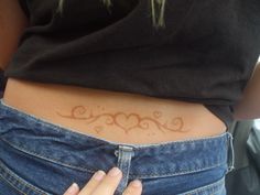 a woman's stomach with hearts and swirls on the side, showing how small it is