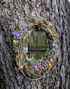 a wreath is hanging on the side of a tree