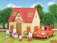 a toy car is parked in front of a doll house with two mice and a cat