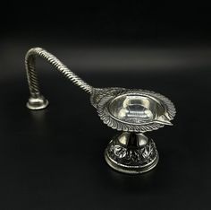 Name of product:  925 Sterling Silver Arti Stand / Arti For Pooja Weight: 137.50 grams. Height:  8.5centimeters. Length: 21.5centimeters Width:  7.5centimeters. FREE EXPRESS SHIPPING -----Feedback::- A satisfied customer is our top priority and your feedback forms the backbone of our success. Don't forget to give positive feedback along with good ratings. Thank You Artistic Silver Jewelry For Festivals, Silver Puja Items, Puja Items, Silver Articles, Diamond Nose Ring, Pooja Items, Silver Pooja Items, Indian Nose Ring, Goddess Decor