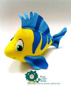 a yellow and blue fish stuffed animal on a white surface