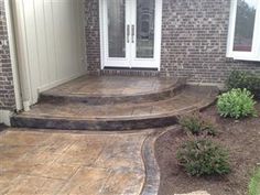 an outdoor patio with steps leading to the front door