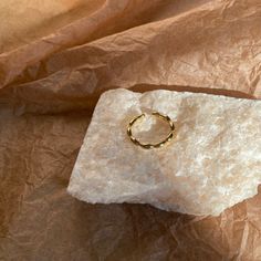 a gold ring sitting on top of a piece of paper