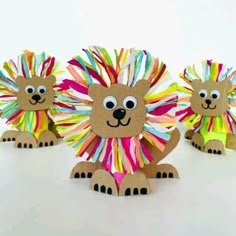 paper lion craft for kids made with construction paper and colored yarns on white background