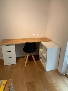 an empty room with a desk and drawers