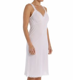 This silky full slip has stretch floral lace around the neckline and at the hem, with ruched soft cups and elastic under the arms for a more custom fit. This slip measures 26" from the waistline to the hem. Stretch lace at the neckline and straps. Cups are soft and ruched for shape. Elastic under the arms provides a more custom fit. Silky nylon is exquisitely soft against your skin. Shadowline's nylon tricot fabric is made in the US. Perfect for wearing under dresses and skirts. Please Note: Thi Tricot Fabric, Under Dress, Soft Cup, Stretch Lace, Halter Formal Dress, Custom Fit, White Formal Dress, Floral Lace, Your Skin