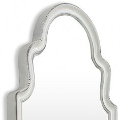 a white mirror that is shaped like an arch