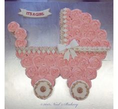 a pink baby carriage made out of cupcakes