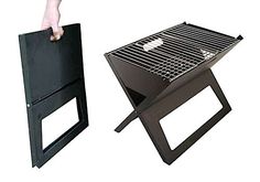 a hand reaching for a grill on top of a small table with an open door