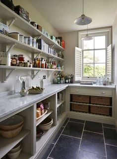 a kitchen filled with lots of counter top space next to a sink and window above it