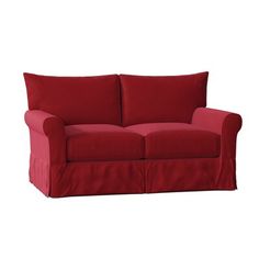 a red couch sitting on top of a white floor