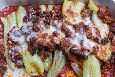 a close up of a plate of food with cheese and vegetables on it, including green peppers