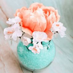 a blue vase filled with pink and white flowers