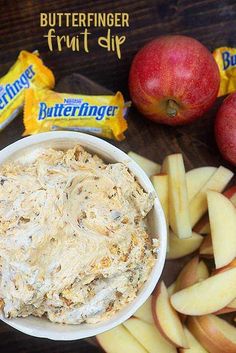 an apple and butterfingerer fruit dip is in a bowl next to some apples