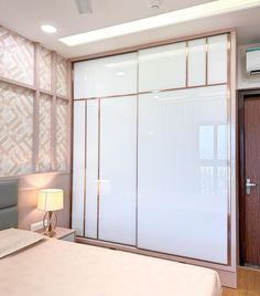 a bedroom with sliding glass doors and a bed in the foreground, next to a wall mounted air conditioner