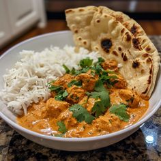 a white bowl filled with rice and meat next to pita bread on top of a counter